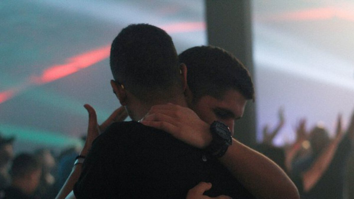 gay couple hugging in a club