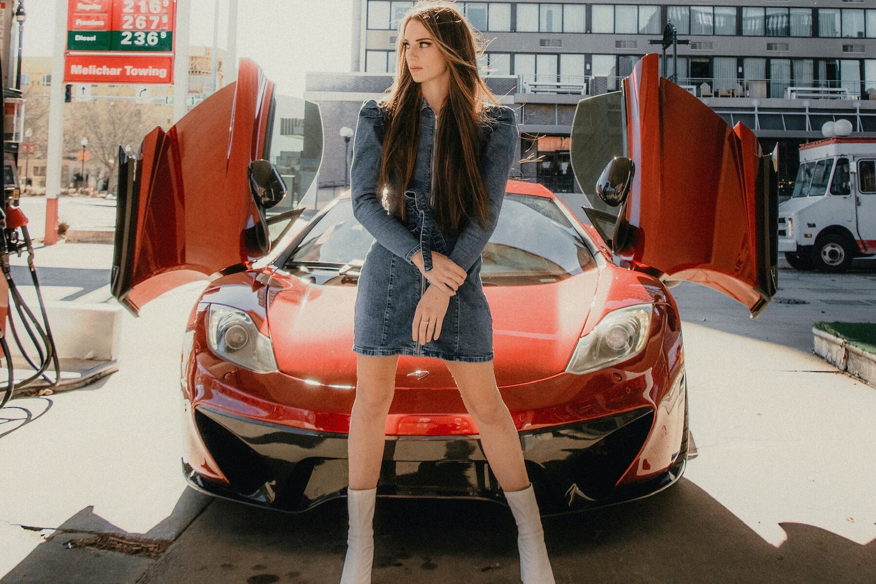 girl standing in front of her sugar daddy's car